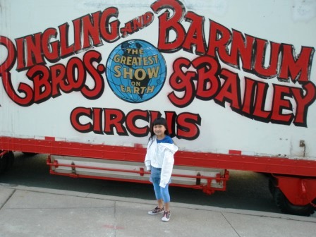 Kasen posing by the circus trailers